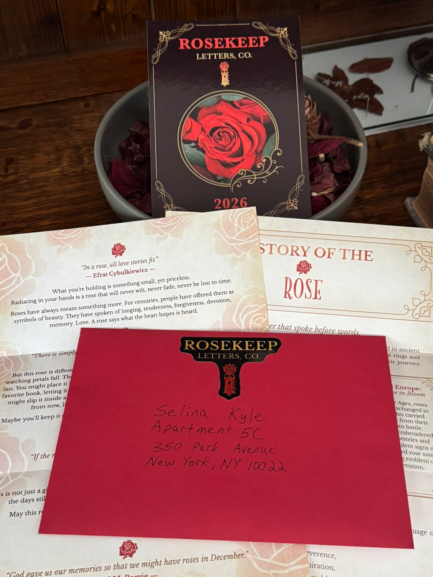 Rosekeep Letters Co. stationery set with a red card and envelope on a textured surface.